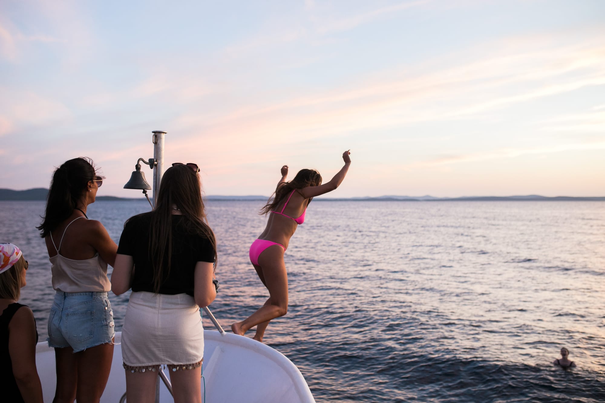 A Caudalie corporate guest jumping into the Adriatic at sunset during a multi-day Dalmatia retreat by Authland