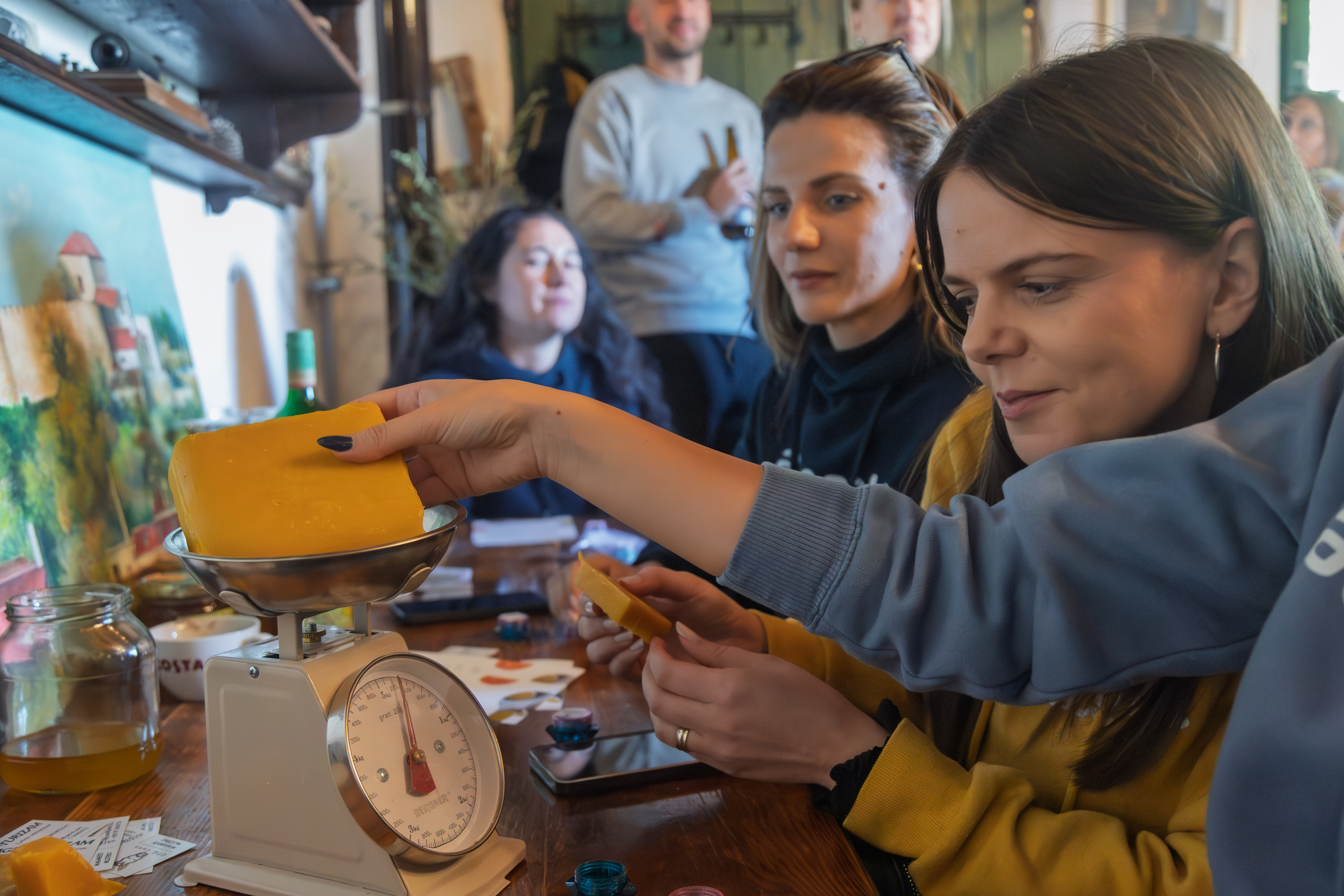 Authland corporate group at a hands-on artisan workshop with a local Croatian producer, learning how award-winning beeswax candles are made