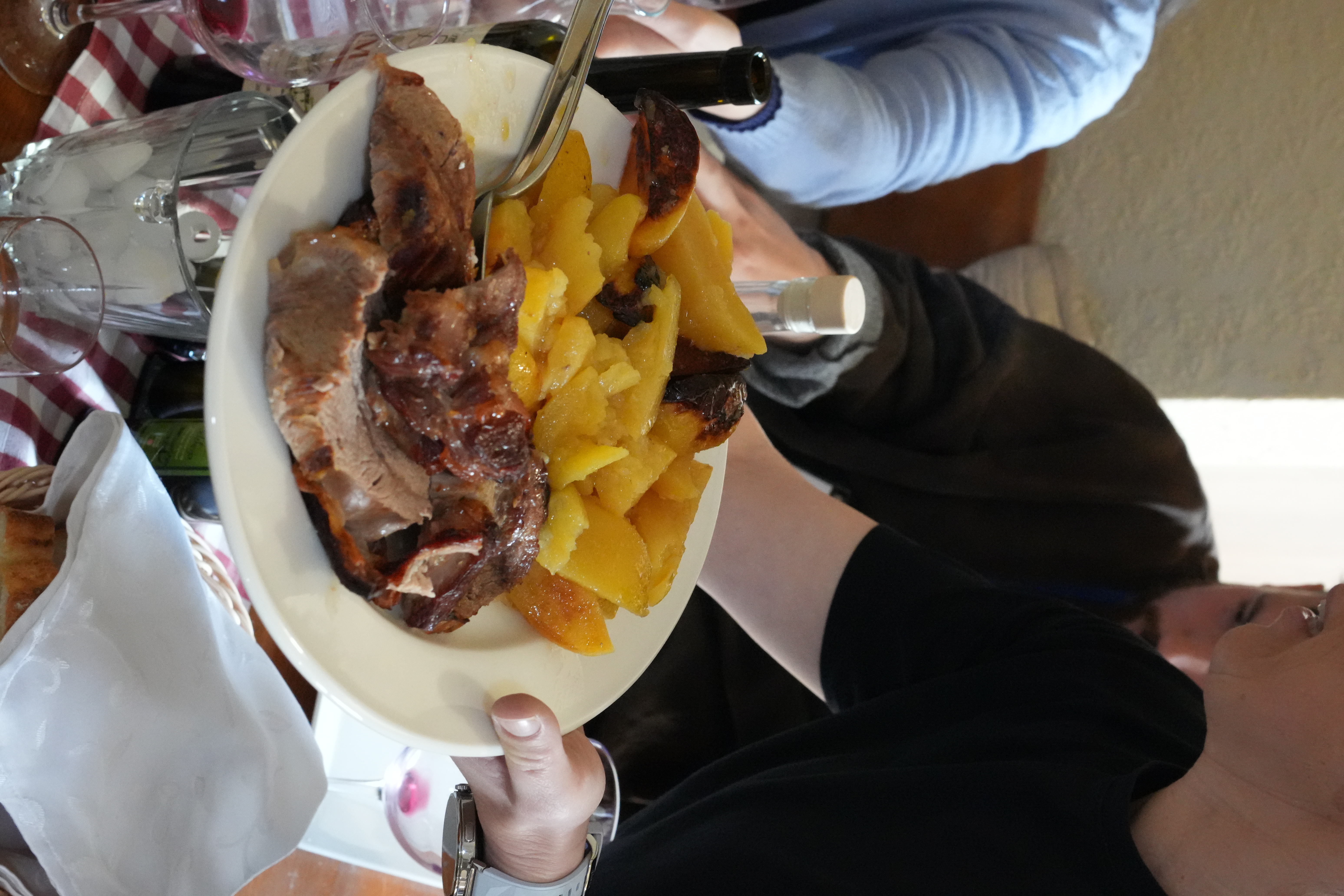 A plate of slow-roasted peka with potatoes served family-style at a Croatian agritourism
