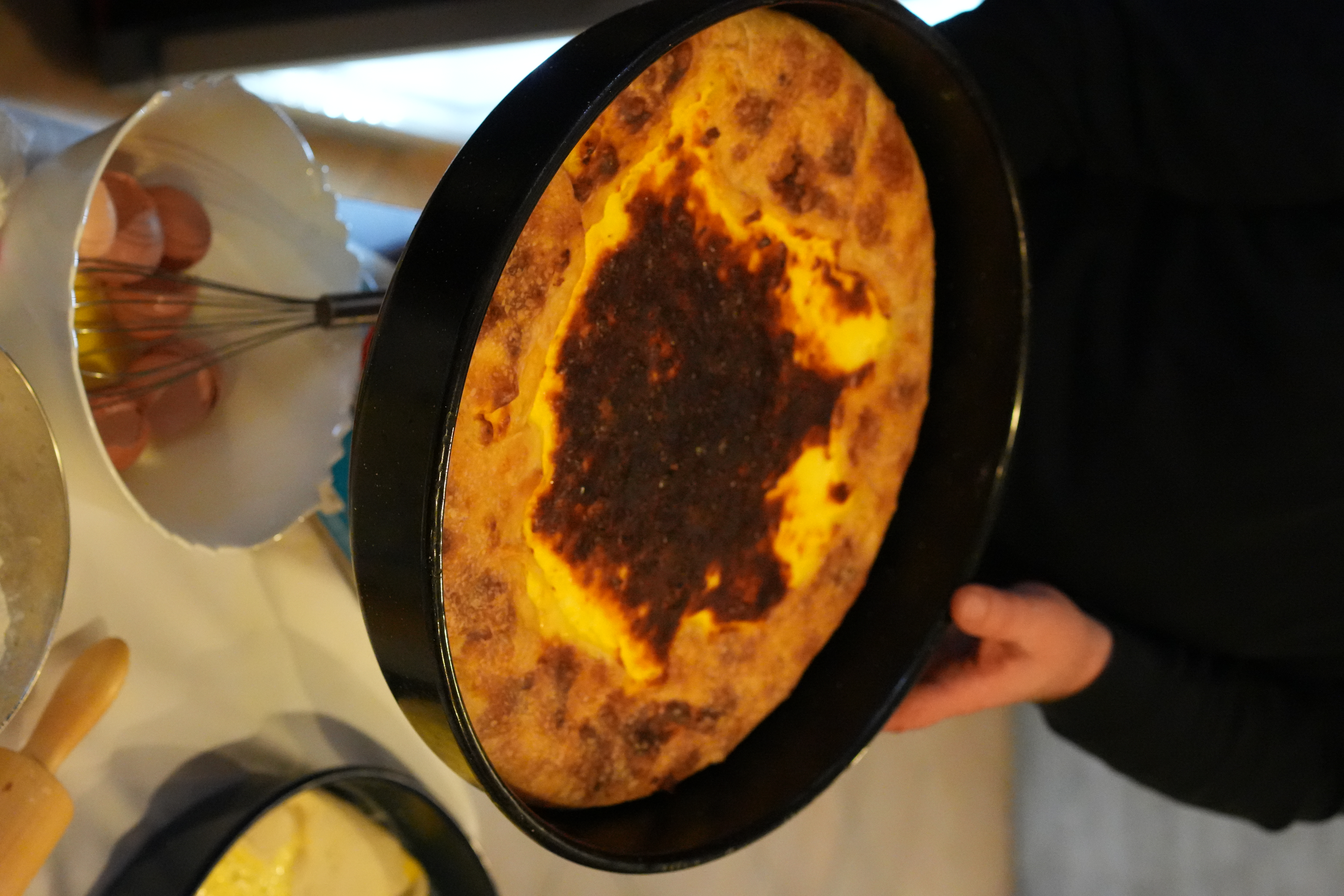A Croatian agritourism cook preparing a traditional milk pie