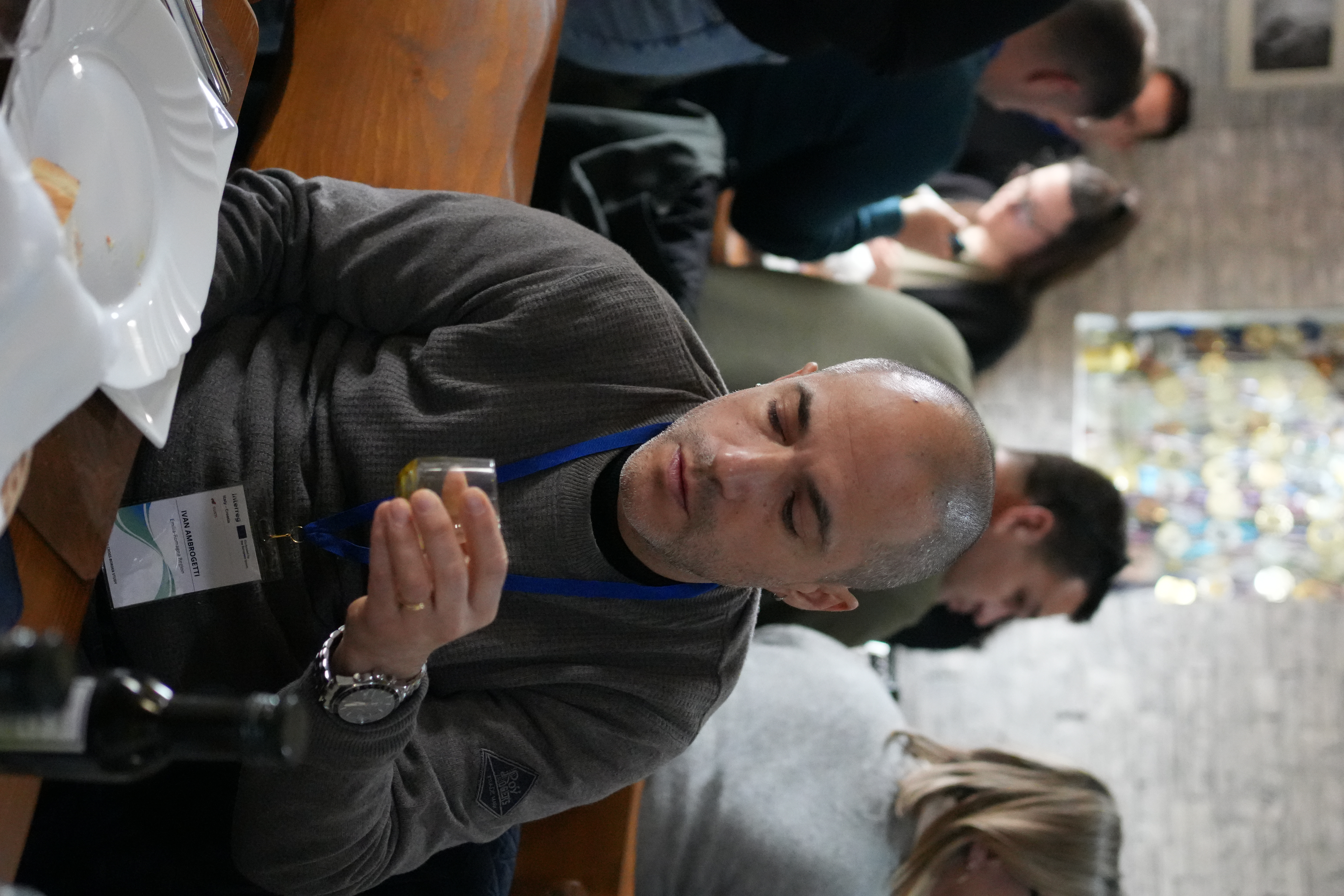 Guests sitting at a Croatian olive-oil and wine producer's tasting room