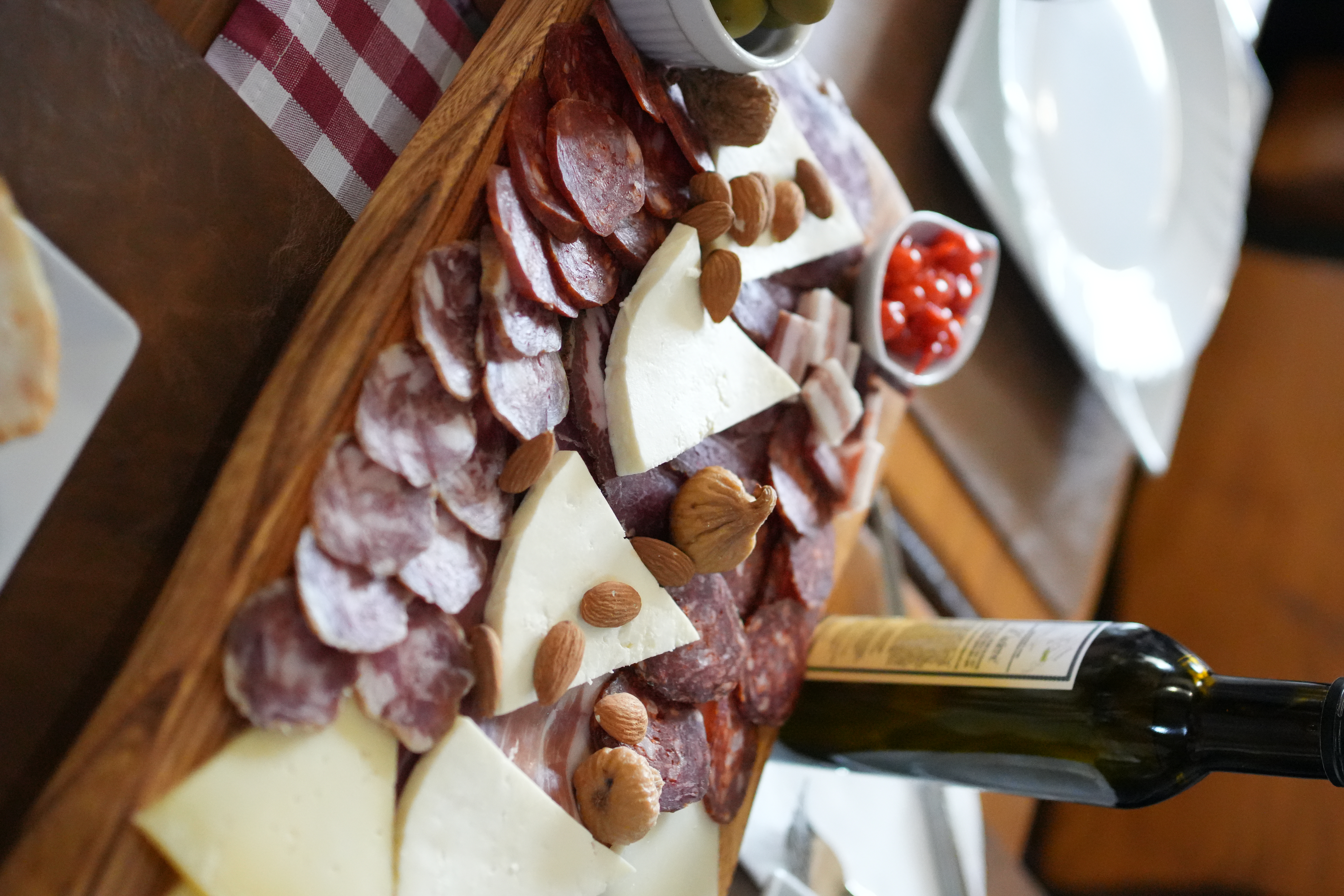 A Croatian charcuterie and cheese board with olives and figs served at a private group tasting