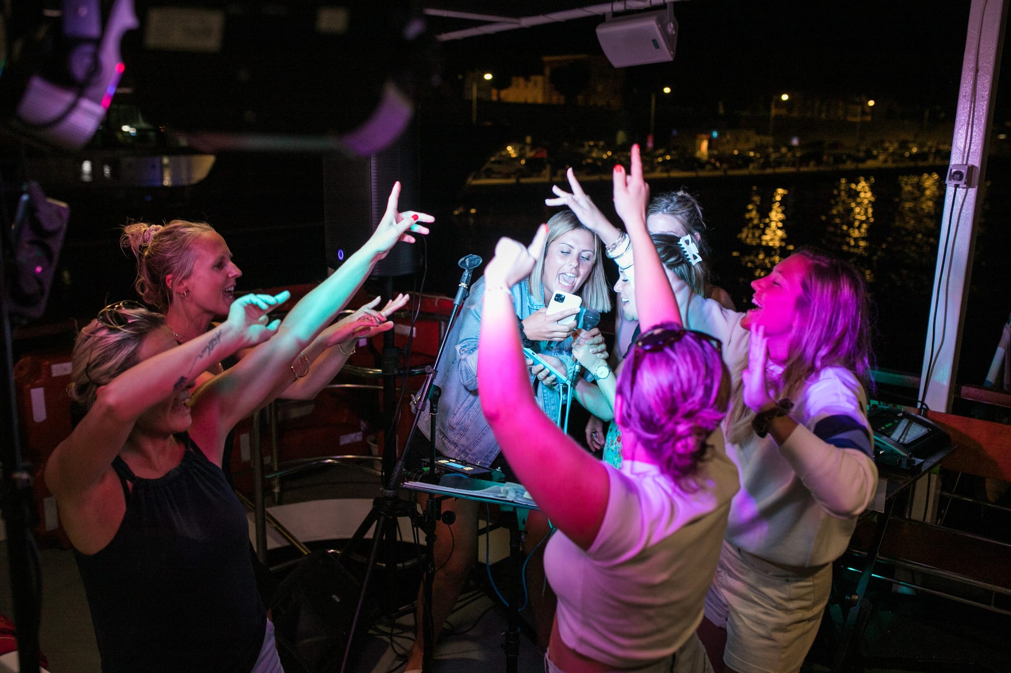 Friends singing on the dance floor of an Authland late-night boat event