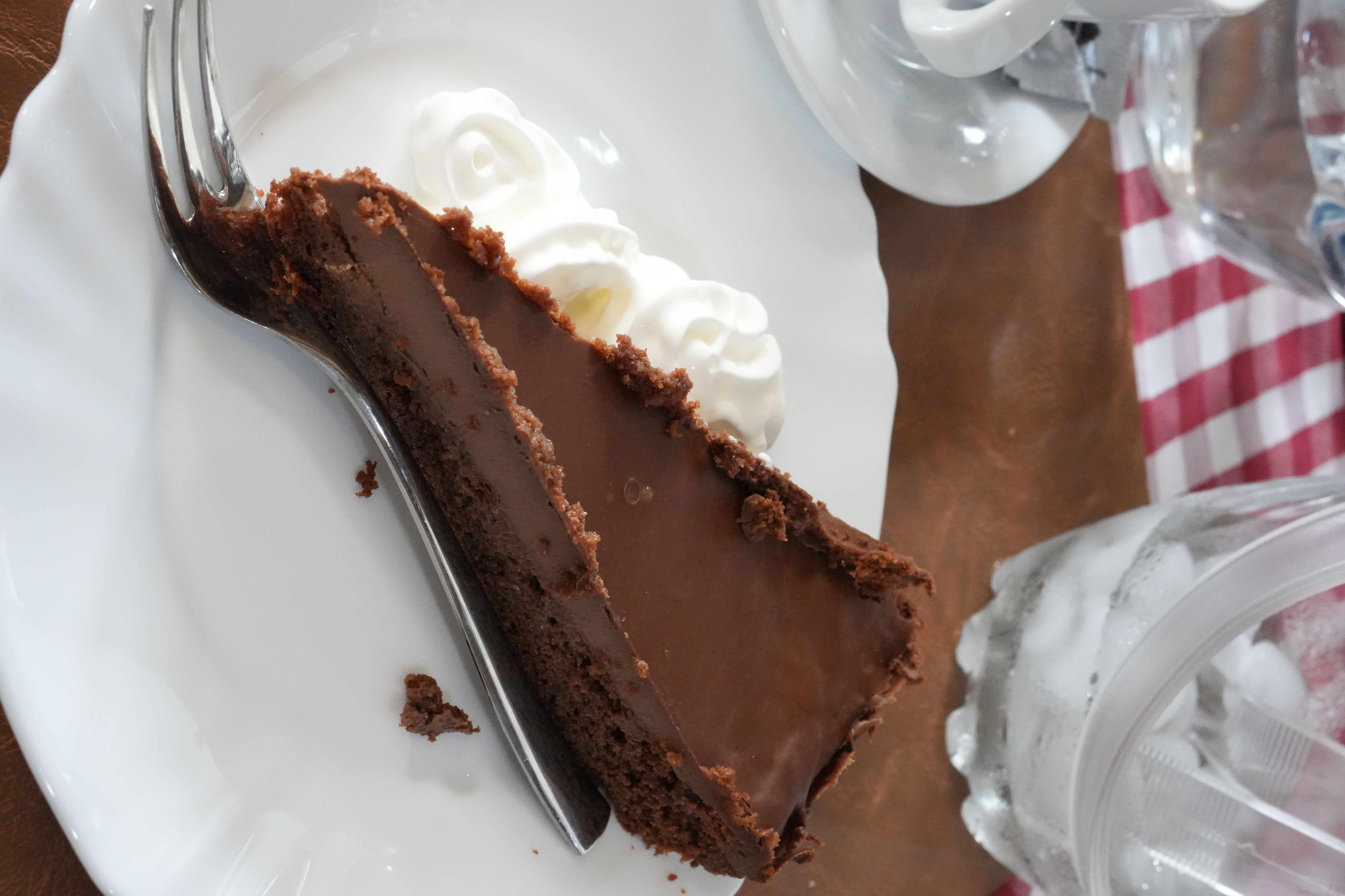 A slice of chocolate dessert with whipped cream served at a Croatian konoba