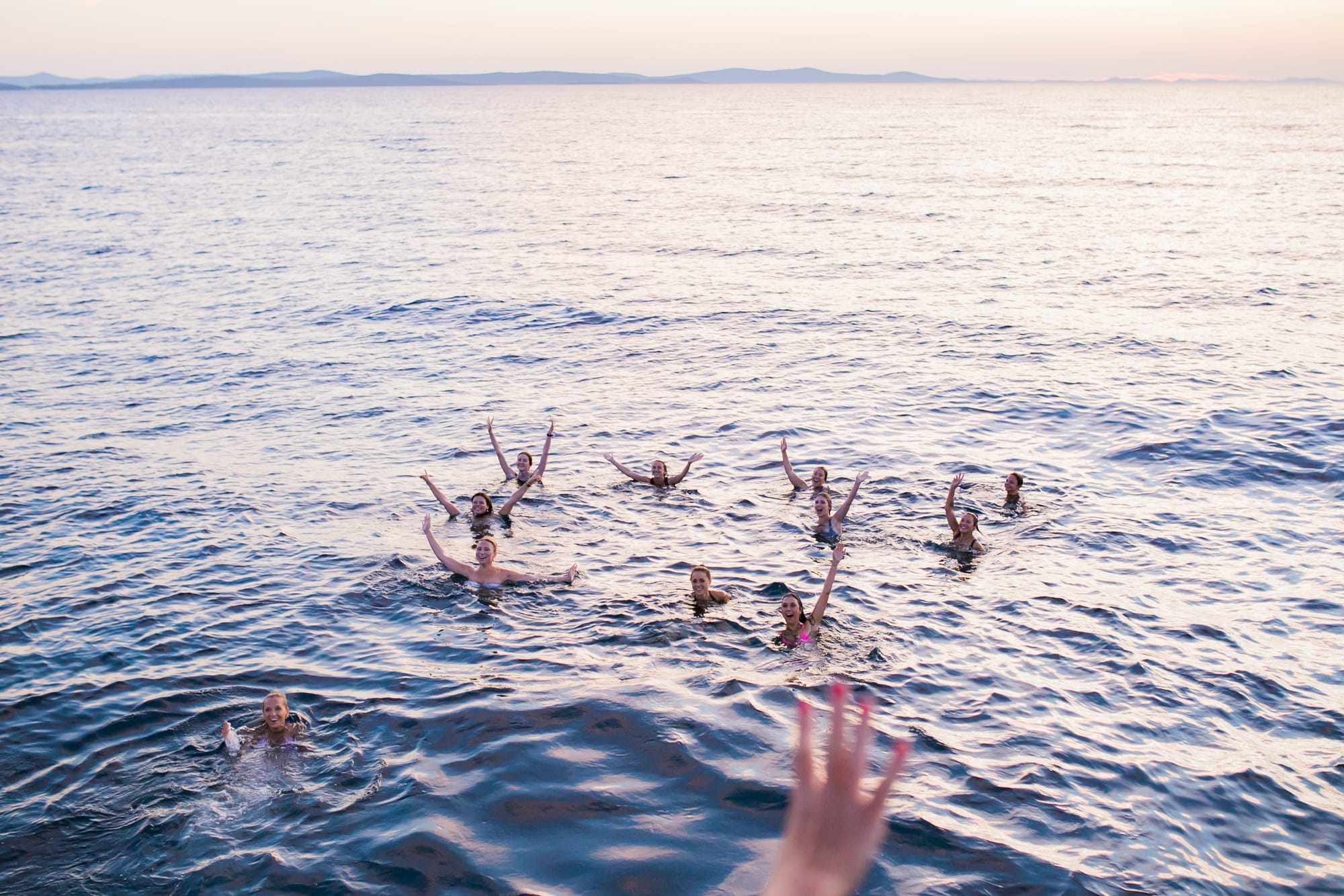 Friends in the Adriatic at sunset after a swim stop on an Authland private boat tour