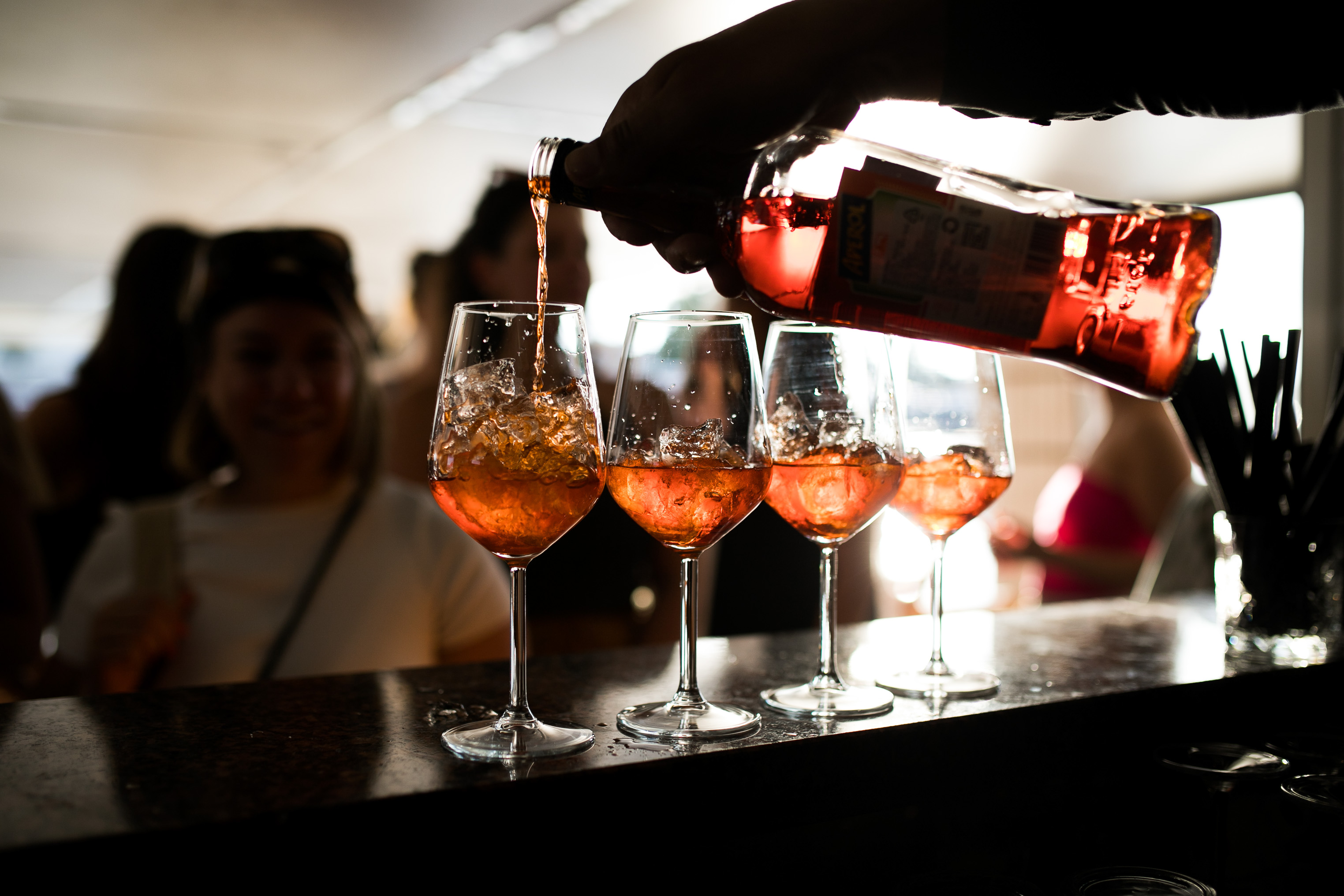 Bartender pouring Aperol Spritz cocktails for a private Authland group