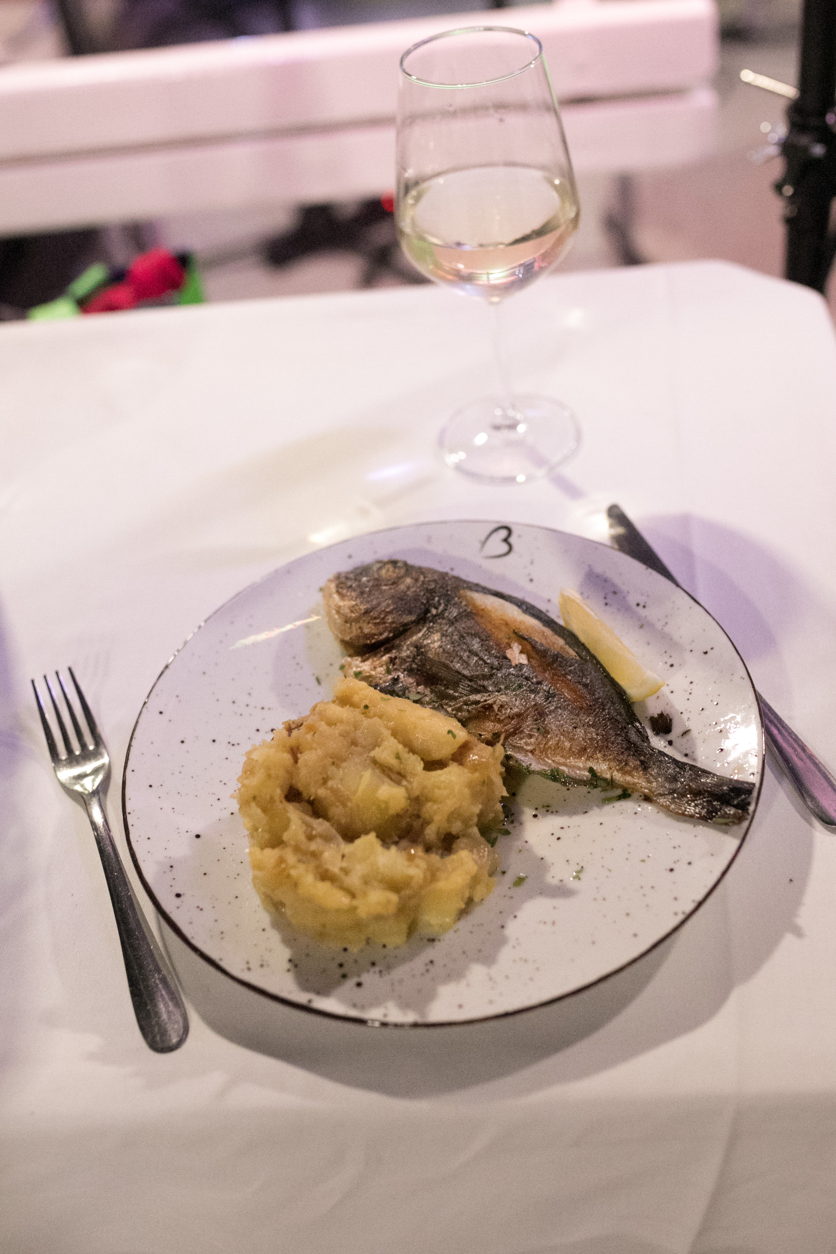 Grilled sea bream with potato and white wine served at a private dinner