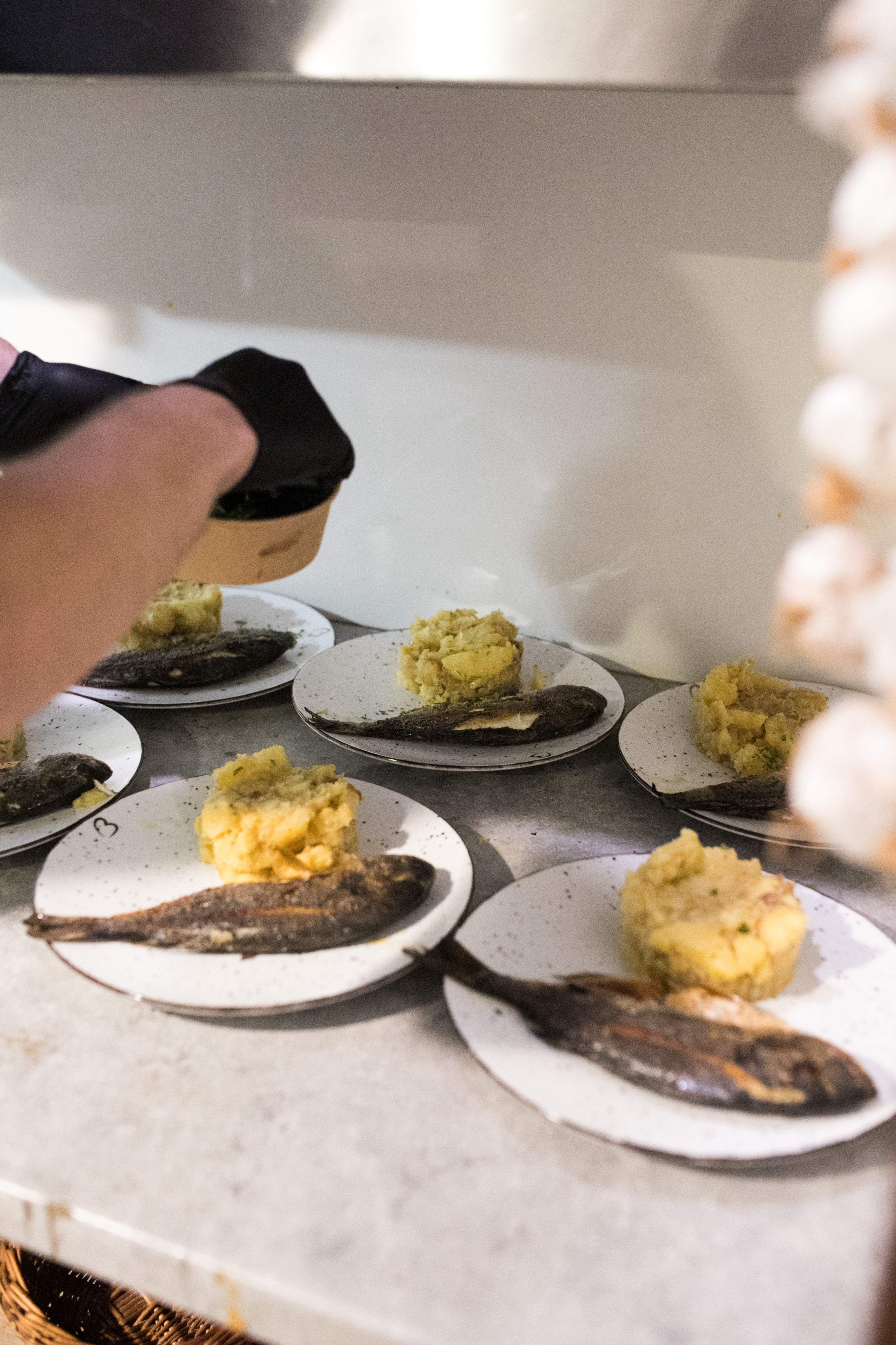 Sea bream and potatoes coming out of the kitchen