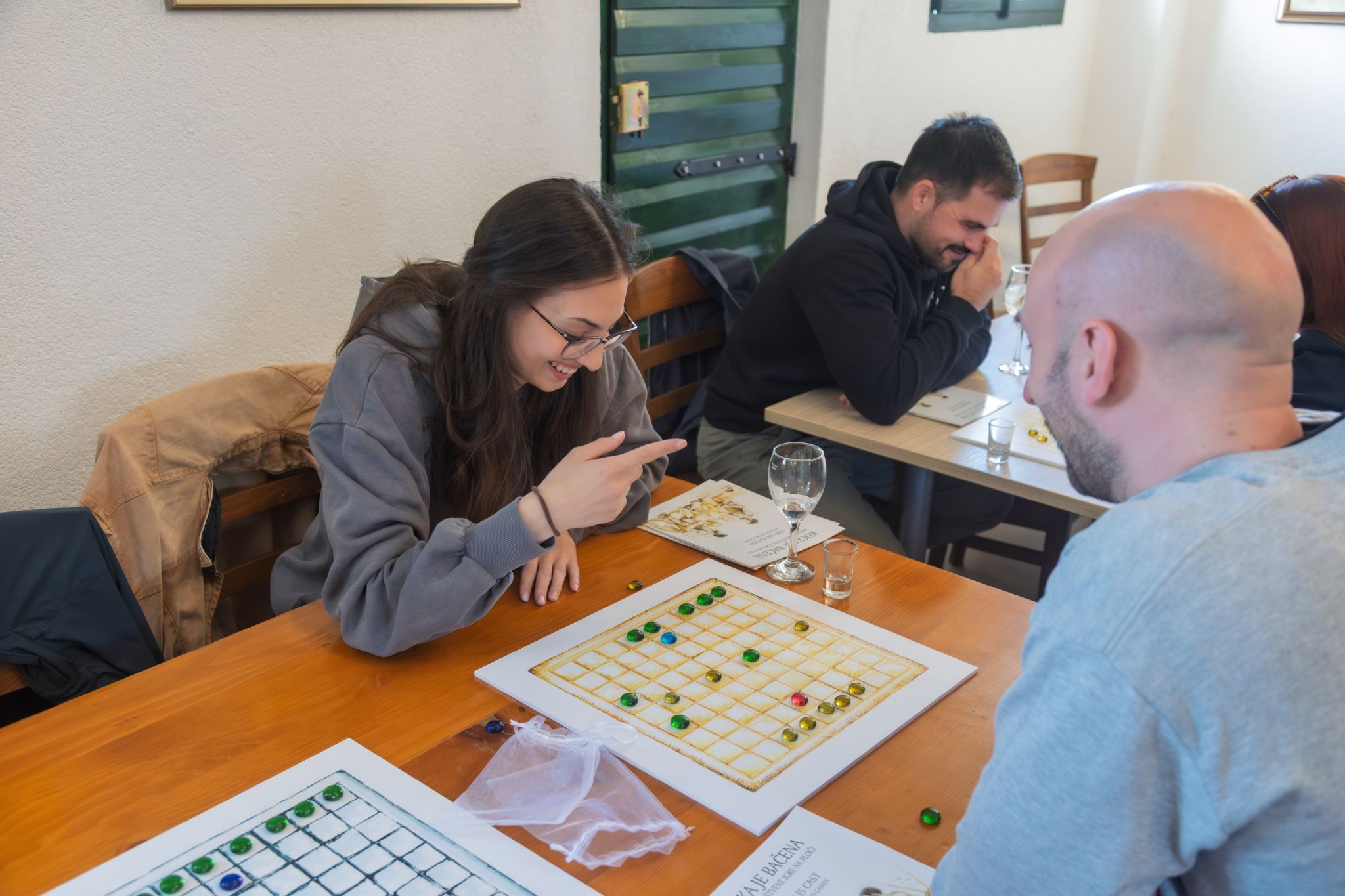 Guests playing an ancient Roman strategy board game during an Authland workshop