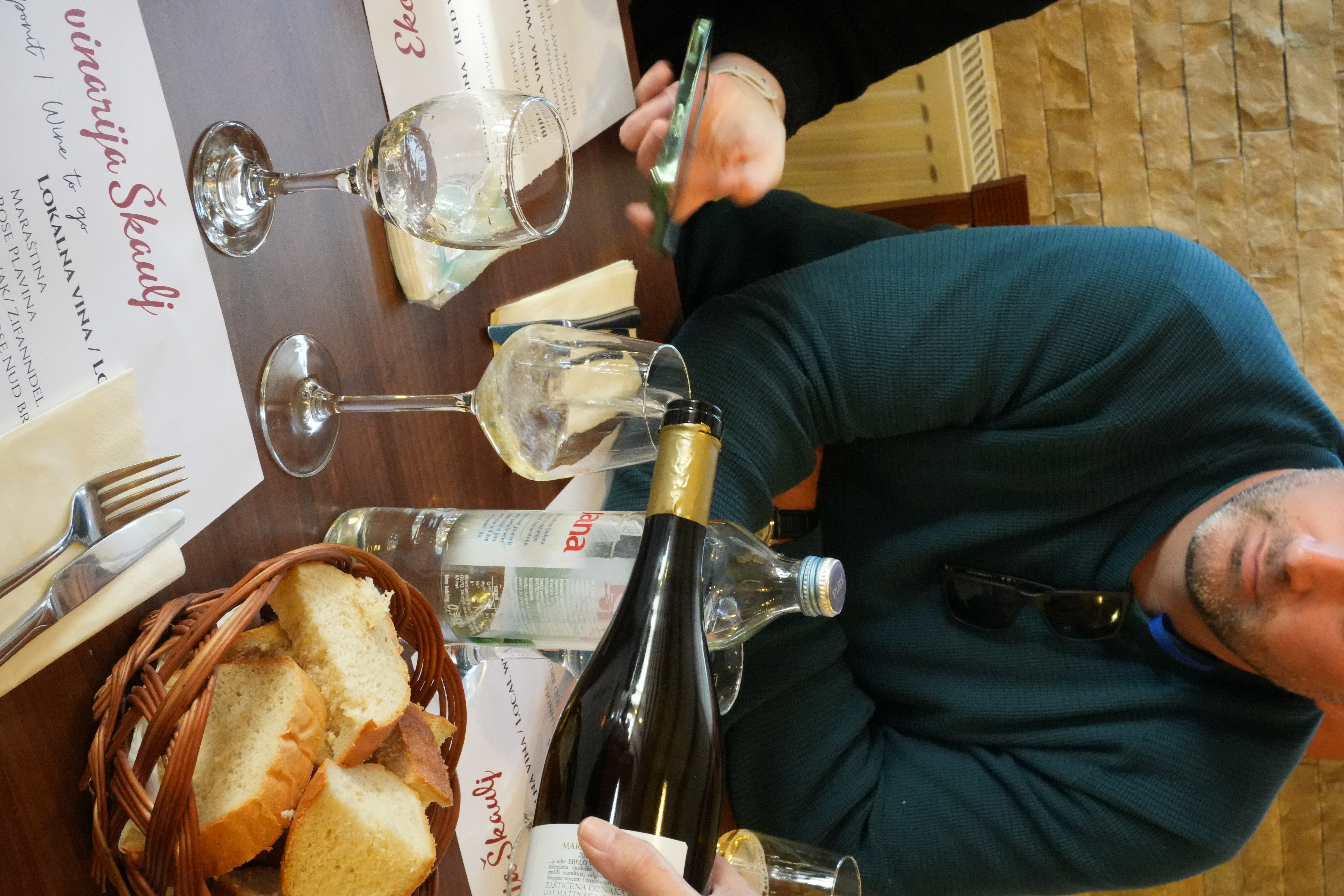 Croatian winemaker pouring white wine for an Authland tasting at Vinarija Škaulj